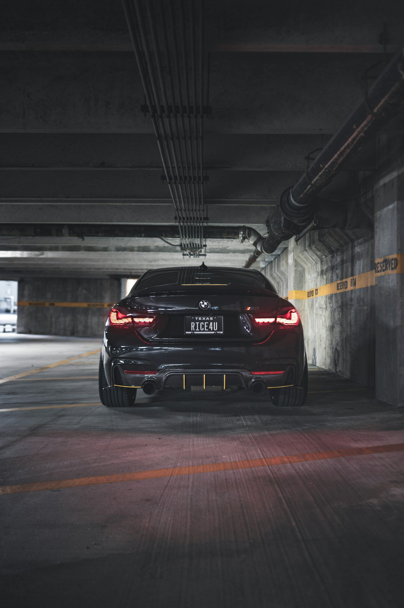 BMW M4 rear view in underground garage